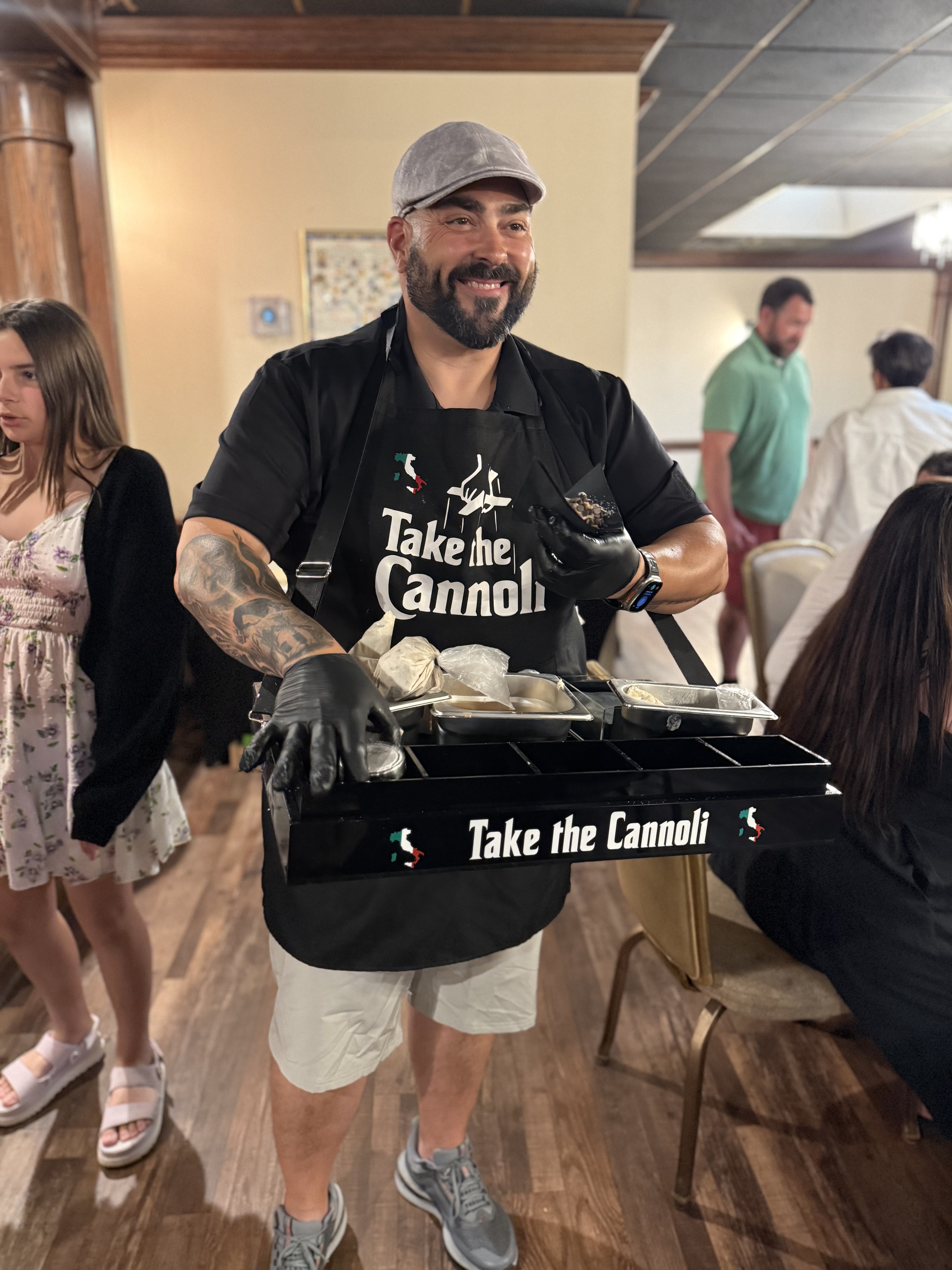 Frank serving cannoli at a catering event
