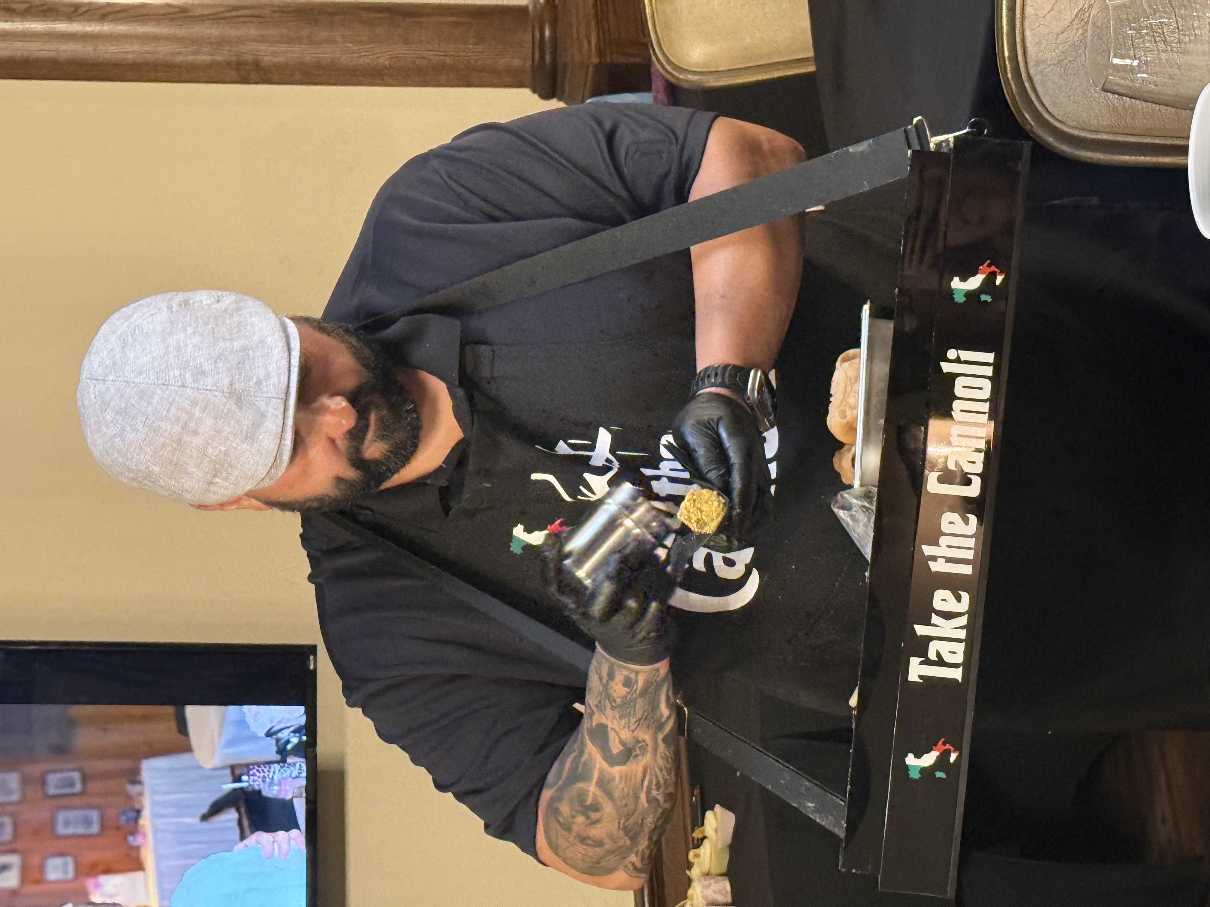 Frank filling a cannoli shell at a catering event